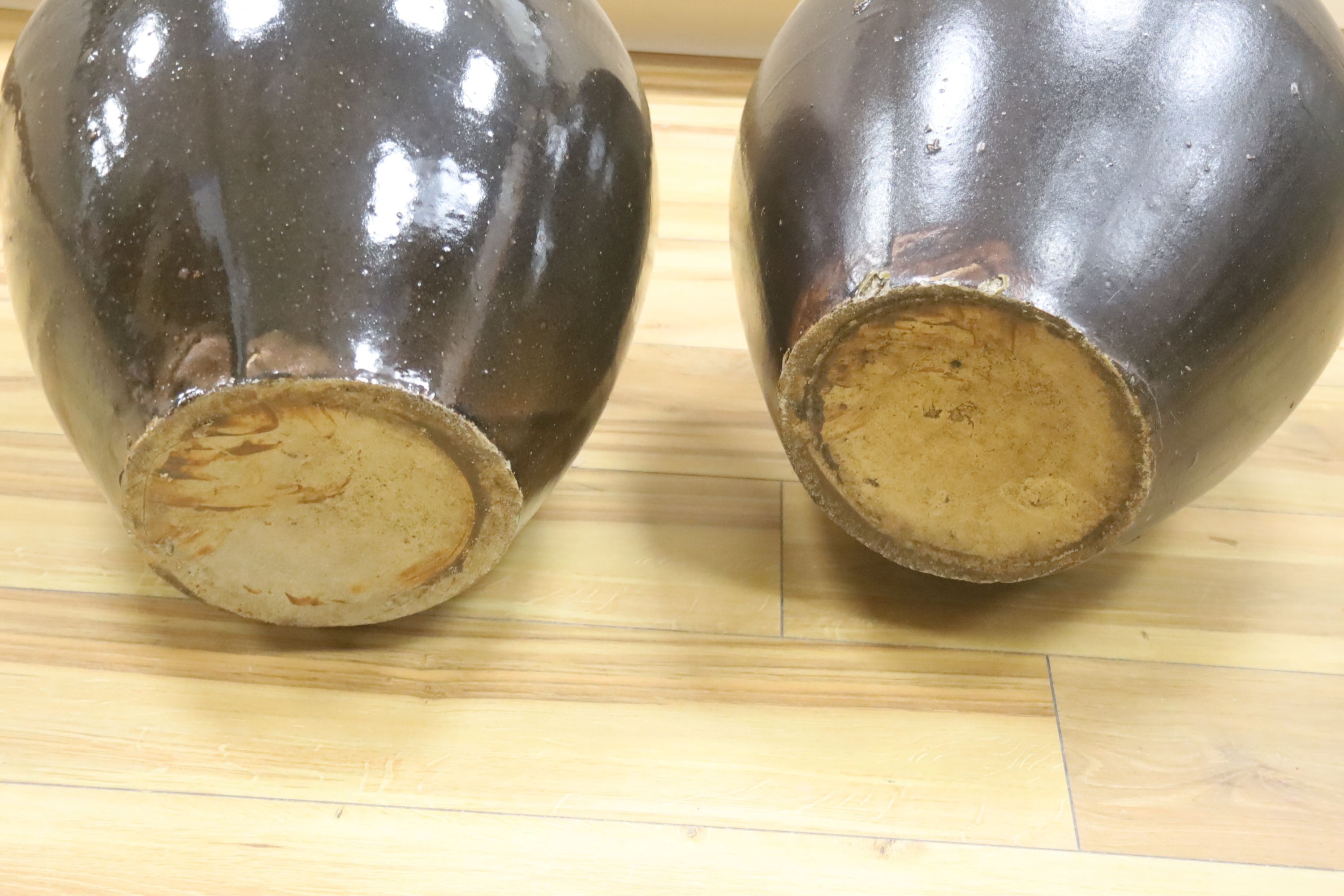 A pair of large monochrome brown glazed jars, height 40cm